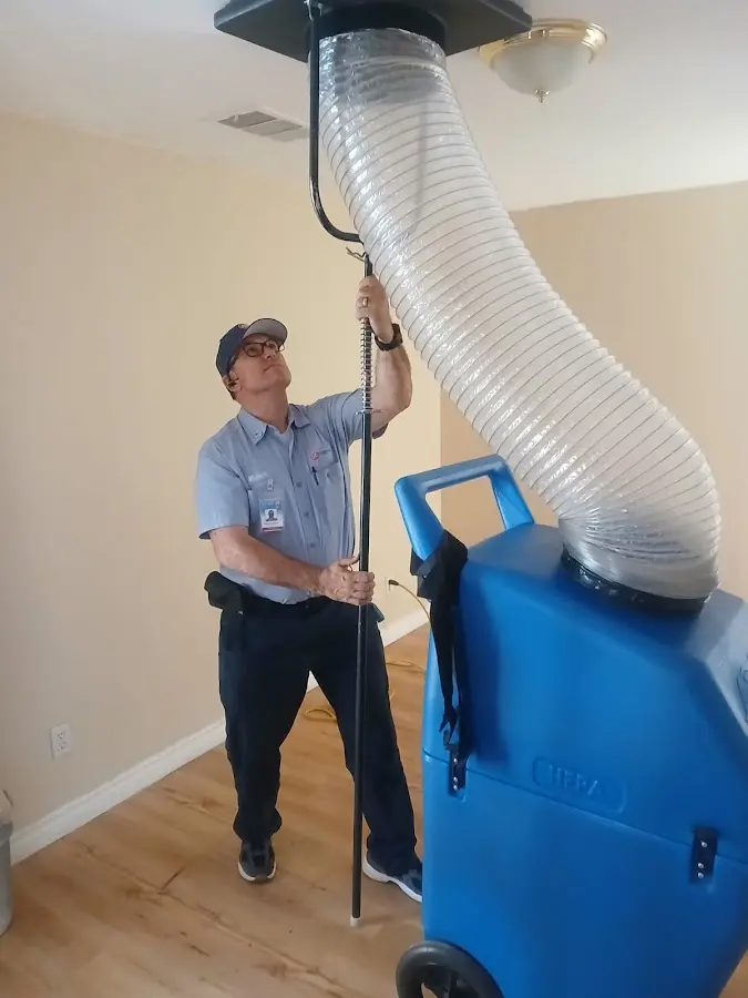 Furnace Tune-Up technician using HEPA equipment in Farmington